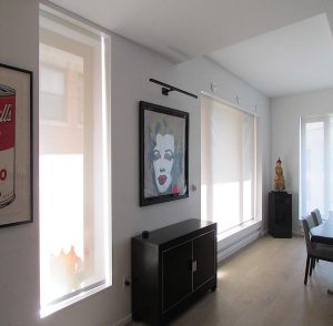 motorized shades in room decorated with modern artwork