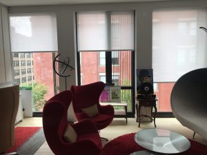 Motorized roller shades in a sitting area