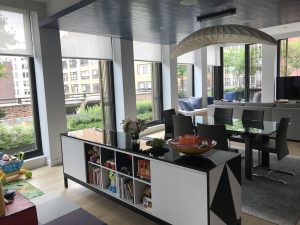 Motorized roller shades in a modern dining room