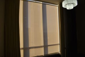 Motorized roller shades blocking the setting sun